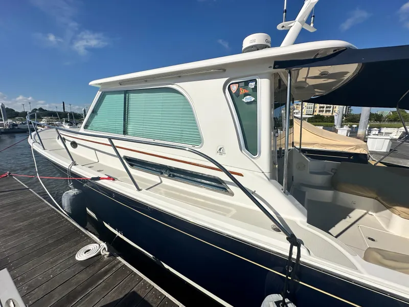 Slide: The Image of 2014 Back Cove 37 yacht docked at marina under clear blue sky. - 8