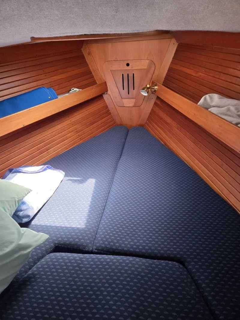 Slide: The Image of Cozy cabin interior of 1993 Freedom Cruising sloop with wooden walls and blue cushions. - 10
