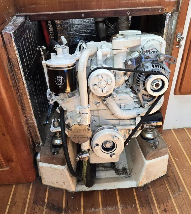 Slide: The Image of Engine of a 1993 Freedom Cruising Sloop, detailed view with components visible. - 12
