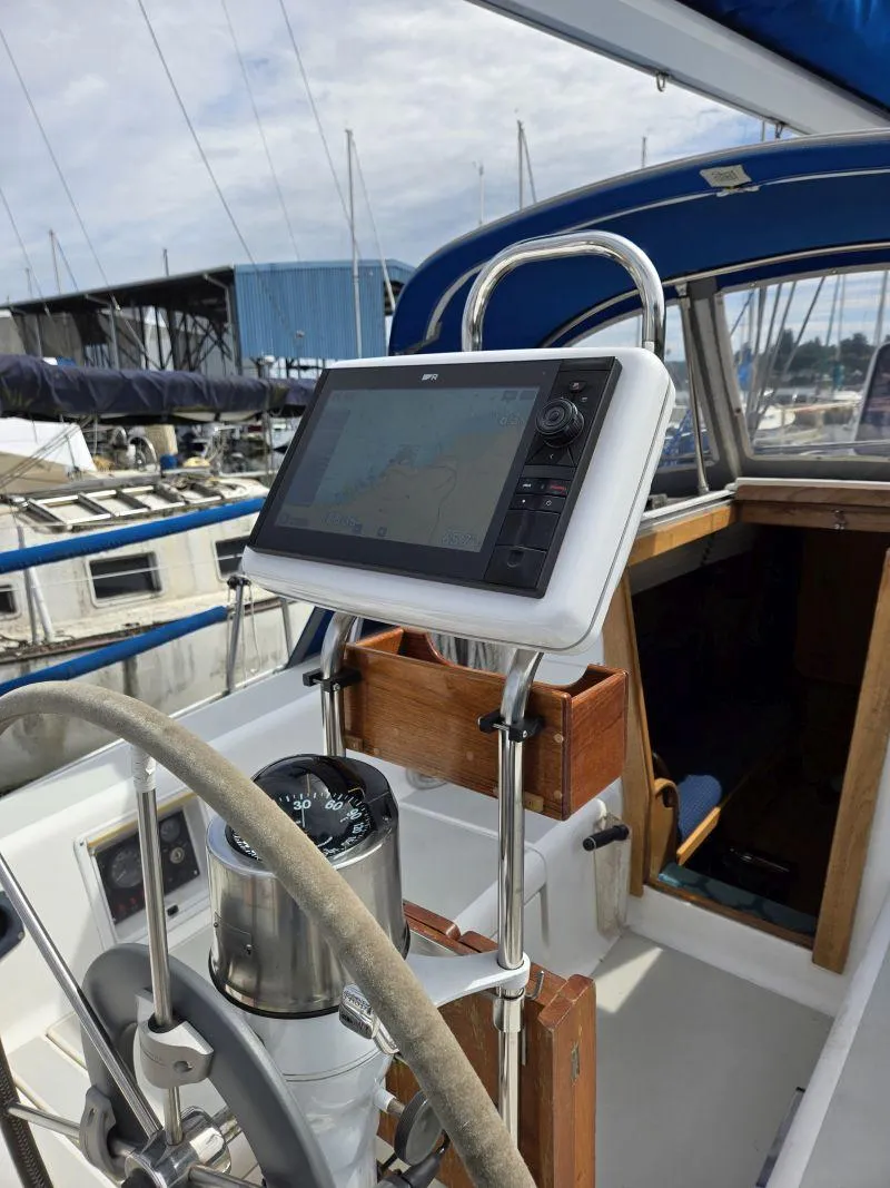 Slide: The Image of Cockpit of 1993 Freedom Cruising Sloop with navigation equipment and steering wheel. - 14