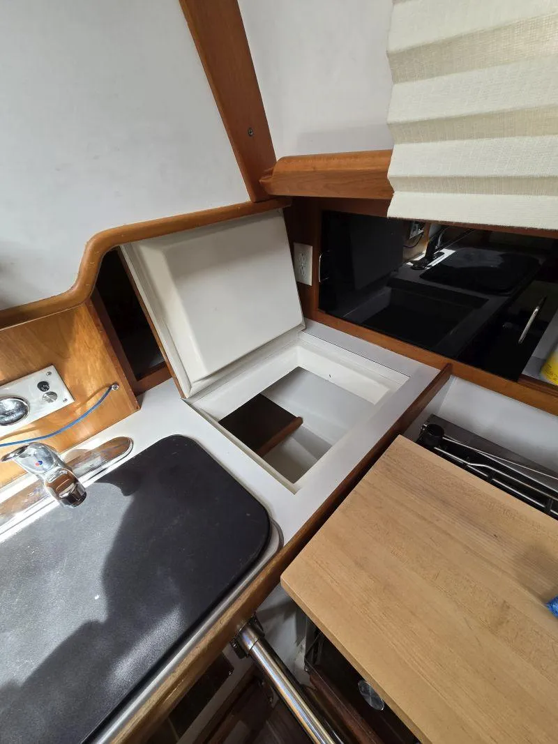 Slide: The Image of Interior of a 1993 Freedom Cruising sloop showing a compact kitchen area. - 17