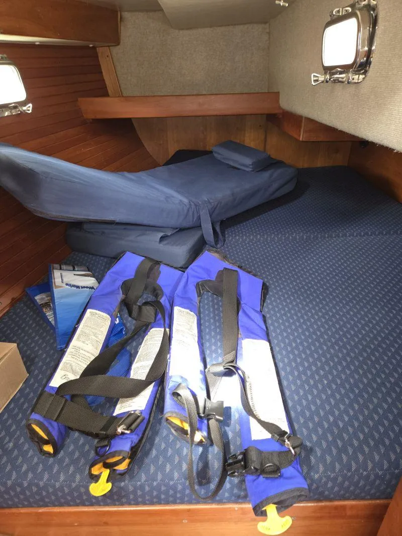 Slide: The Image of Interior cabin of 1993 Freedom Cruising sloop with blue life jackets and bedding. - 21