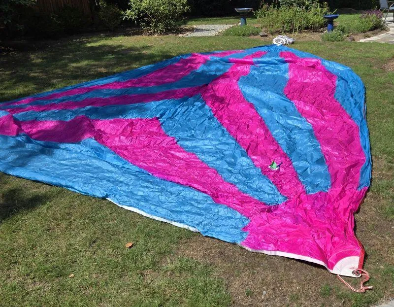 Slide: The Image of Colorful sail from a 1993 Freedom Cruising sloop, laid out on grass. - 29