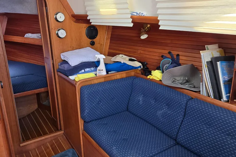 Slide: The Image of Cozy interior of 1993 Freedom Cruising sloop with blue seating and wooden accents. - 31