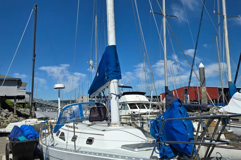 Slide: The Image of 1993 Freedom Cruising Sloop docked at marina under clear blue sky. - 36