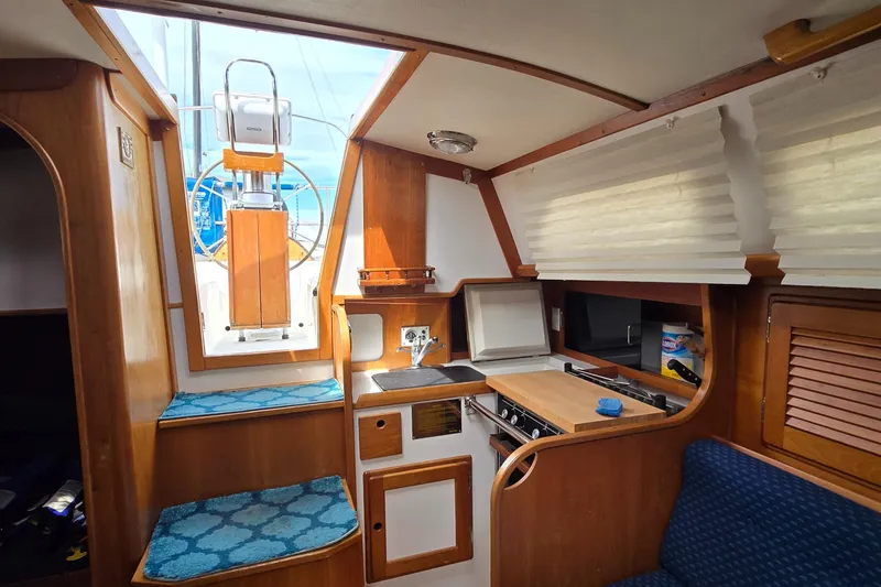 Slide: The Image of Interior of 1993 Freedom Cruising Sloop with compact kitchen and seating area. - 39