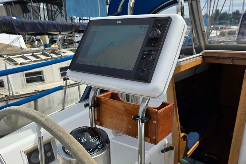 Slide: The Image of Cockpit of 1993 Freedom Cruising Sloop with navigation display and compass. - 43