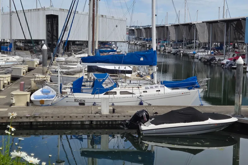 Slide: The Image of Instruction manuals for Raymarine and Vesper marine equipment on a wooden surface. - 46