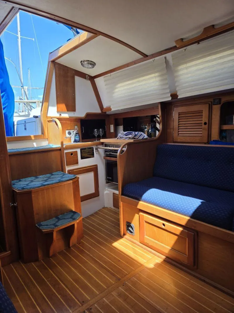 Slide: The Image of Interior of 1993 Freedom Cruising Sloop with wooden finish and blue upholstery. - 6