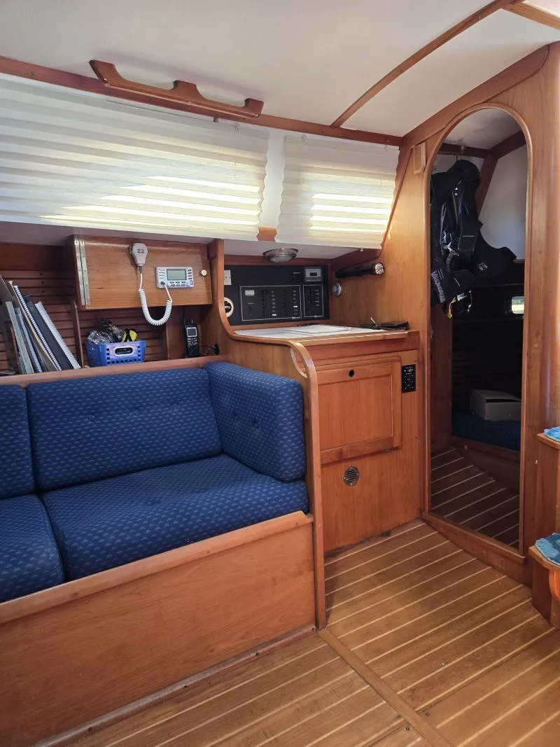 Slide: The Image of Interior of 1993 Freedom Cruising Sloop with wooden finish and blue seating. - 8