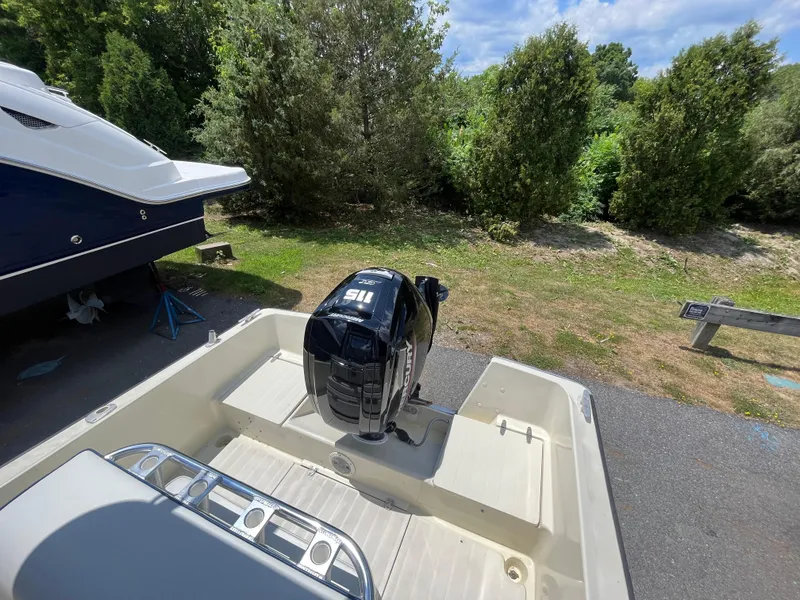 Slide: The Image of 1975 SeaCraft 20 Classic boat with Mercury outboard motor, parked near greenery. - 10