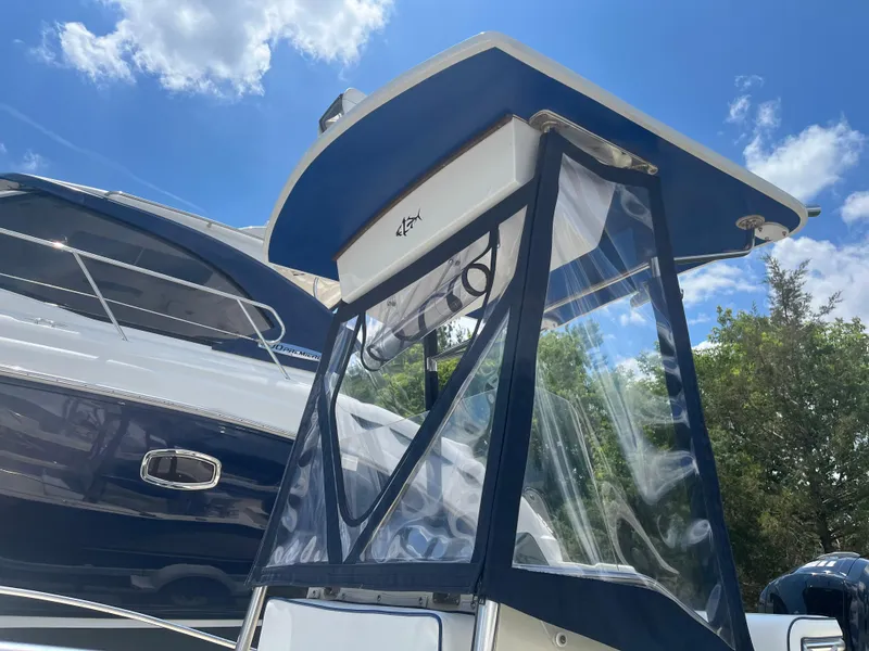Slide: The Image of 1975 SeaCraft 20 Classic boat with canopy, under a clear blue sky. - 8