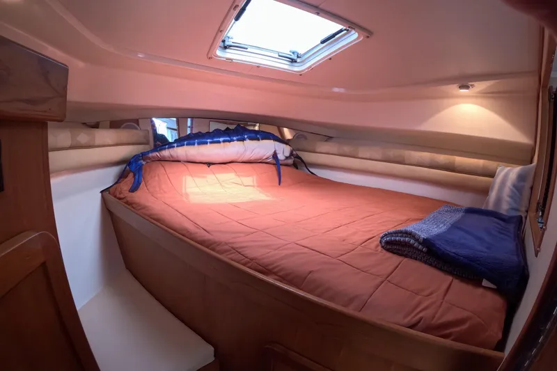 Slide: The Image of Interior cabin of 2004 Stamas 370 Express with cozy bed and overhead hatch. - 10
