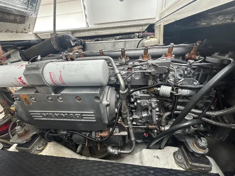 Slide: The Image of Engine compartment of a 2004 Stamas 370 Express boat, featuring a Yanmar engine. - 13