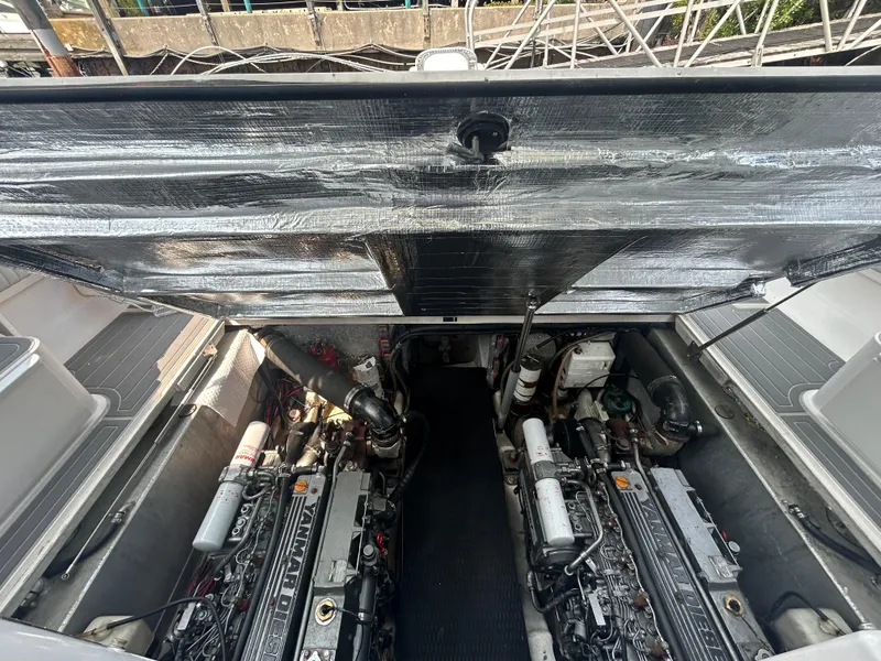 Slide: The Image of Engine compartment of a 2004 Stamas 370 Express boat, showcasing dual Yanmar diesel engines. - 14