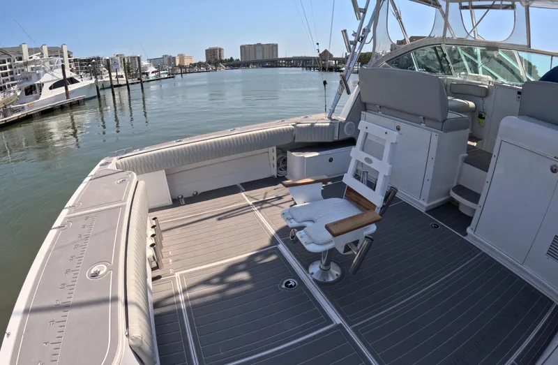 Slide: The Image of 2004 Stamas 370 Express boat interior with fishing chair, docked in a marina. - 5