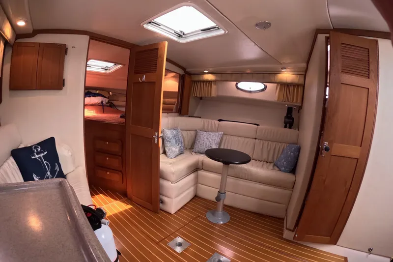 Slide: The Image of 2004 Stamas 370 Express cabin interior with cozy seating and wooden accents. - 6