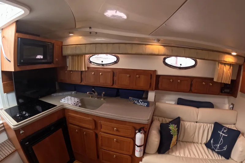 Slide: The Image of Interior of 2004 Stamas 370 Express yacht with kitchen and seating area. - 7