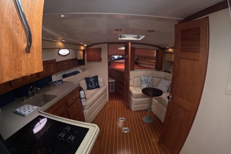 Slide: The Image of Interior of 2004 Stamas 370 Express yacht with cozy seating and wooden cabinetry. - 8