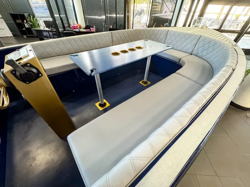 Slide: The Image of Interior of 2025 Vision Marine Technologies Volt 180 boat with seating and table. - 6