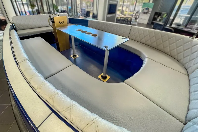 Slide: The Image of 2025 Vision Marine Technologies Volt 180 boat interior with modern seating and table design. - 5