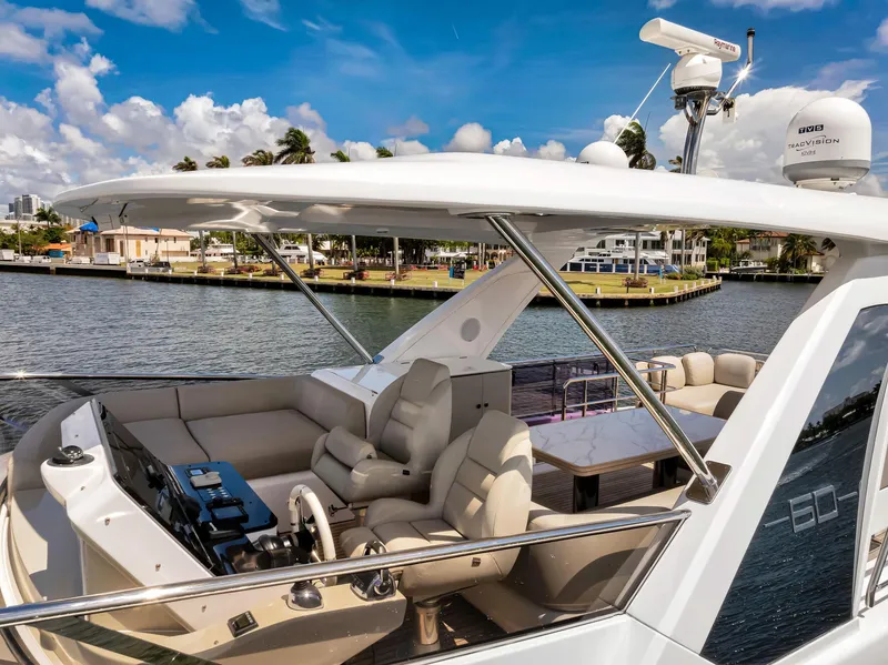 Slide: The Image of 2022 Azimut Fly 60 yacht with luxurious seating and navigation equipment on a sunny day. - 11