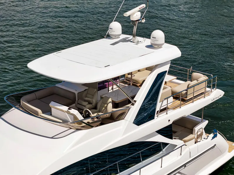 Slide: The Image of 2022 Azimut Fly 60 yacht with spacious flybridge and luxurious seating on the water. - 14