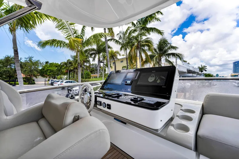 Slide: The Image of Interior view of 2022 Azimut Fly 60 yacht with modern helm and palm trees outside. - 21