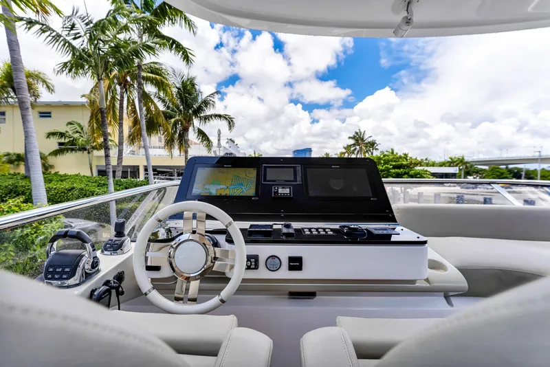 Slide: The Image of Helm of 2022 Azimut Fly 60 yacht with modern controls and tropical backdrop. - 23