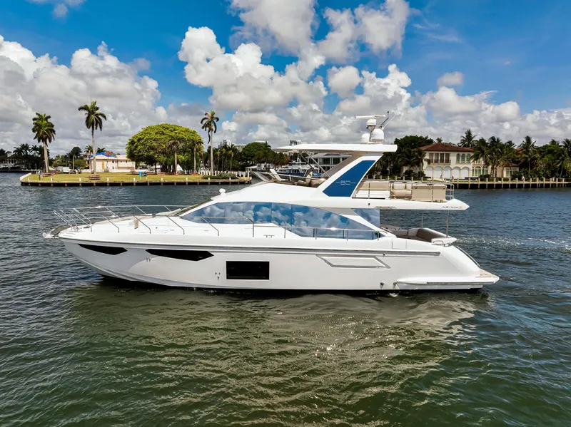 Slide: The Image of 2022 Azimut Fly 60 yacht cruising on a sunny day with palm trees in the background. - 3
