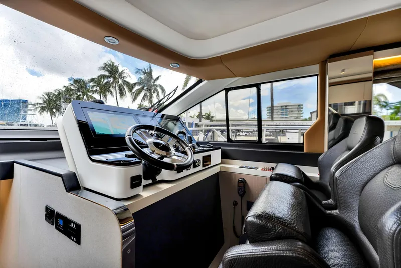 Slide: The Image of Luxurious 2022 Azimut Fly 60 yacht cockpit with modern steering and navigation controls. - 38