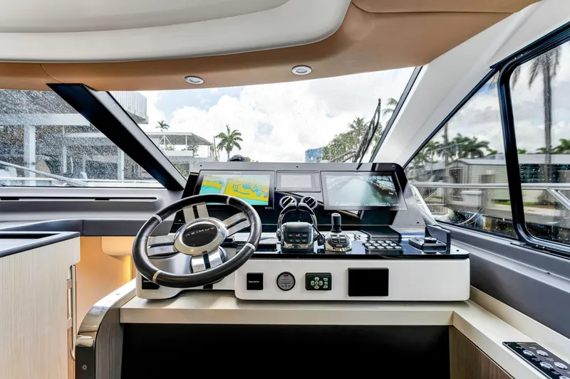Slide: The Image of Helm of 2022 Azimut Fly 60 yacht with modern navigation equipment and steering wheel. - 39