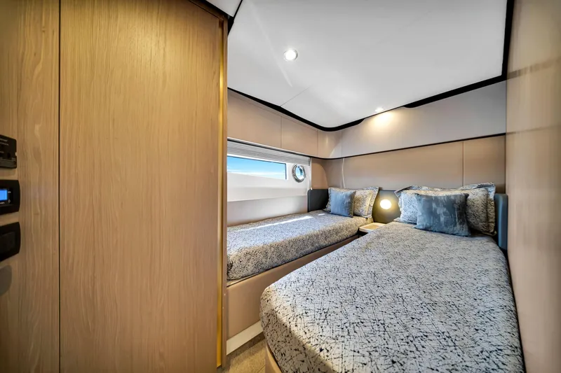 Slide: The Image of Luxurious twin cabin interior of 2022 Azimut Fly 60 yacht, featuring modern design and cozy bedding. - 43