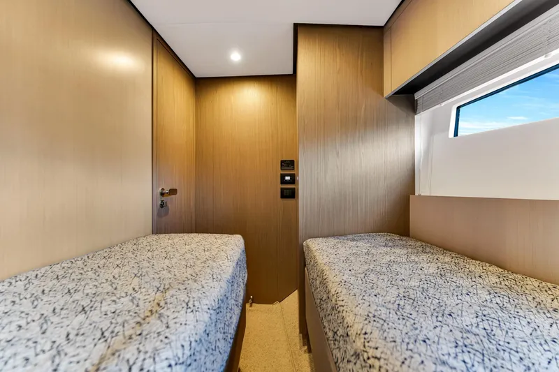 Slide: The Image of Twin cabin interior of 2022 Azimut Fly 60 yacht, featuring modern design and window view. - 45
