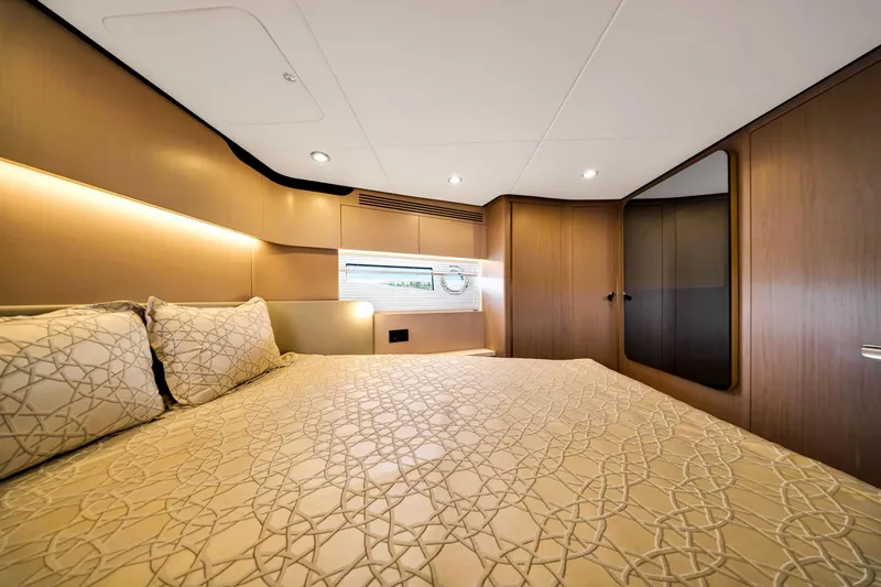 Slide: The Image of Luxurious bedroom interior of 2022 Azimut Fly 60 yacht with elegant bedding and wood paneling. - 47