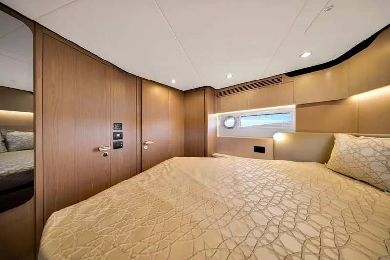 Slide: The Image of Luxurious bedroom interior of 2022 Azimut Fly 60 yacht with elegant wood paneling. - 48