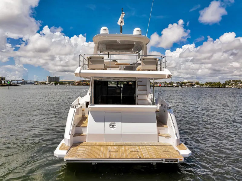 Slide: The Image of Azimut Fly 60 yacht, 2022 model, rear view on water under blue sky. - 8