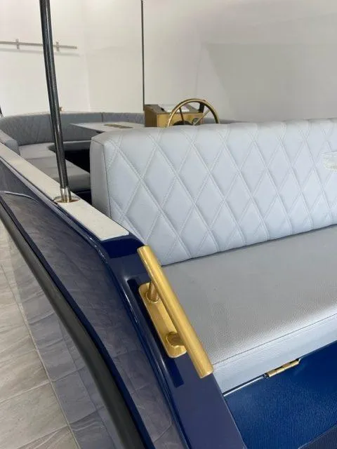 Slide: The Image of 2023 Vision Marine Technologies Volt 180 boat interior with elegant seating and gold accents. - 10