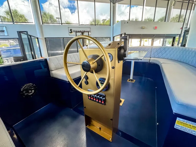 Slide: The Image of 2025 Vision Marine Technologies Volt 180 boat interior with steering wheel and seating. - 3