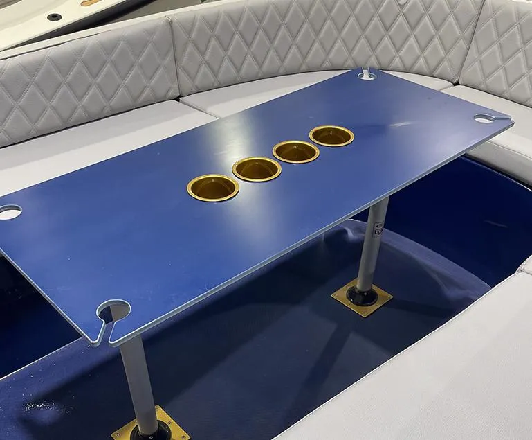 Slide: The Image of 2023 Vision Marine Technologies Volt 180 boat interior with blue table and cup holders. - 4