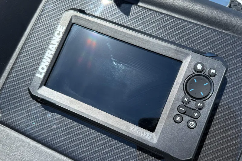 Slide: The Image of Handheld Lowrance device on carbon fiber surface, featuring buttons and screen. - 10