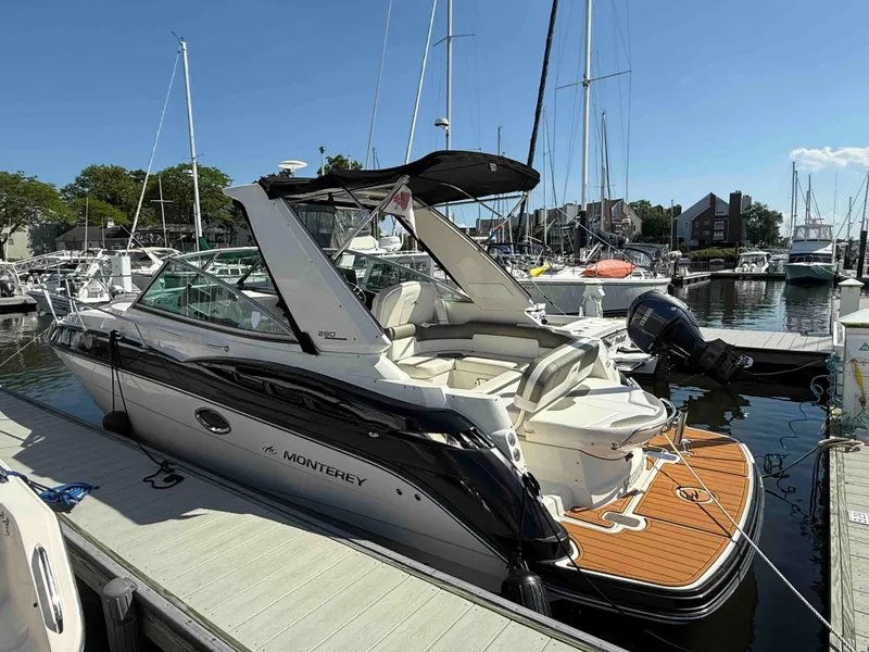 The Image of 2013 Monterey 280 SCR boat docked at a marina under clear blue skies. - 0