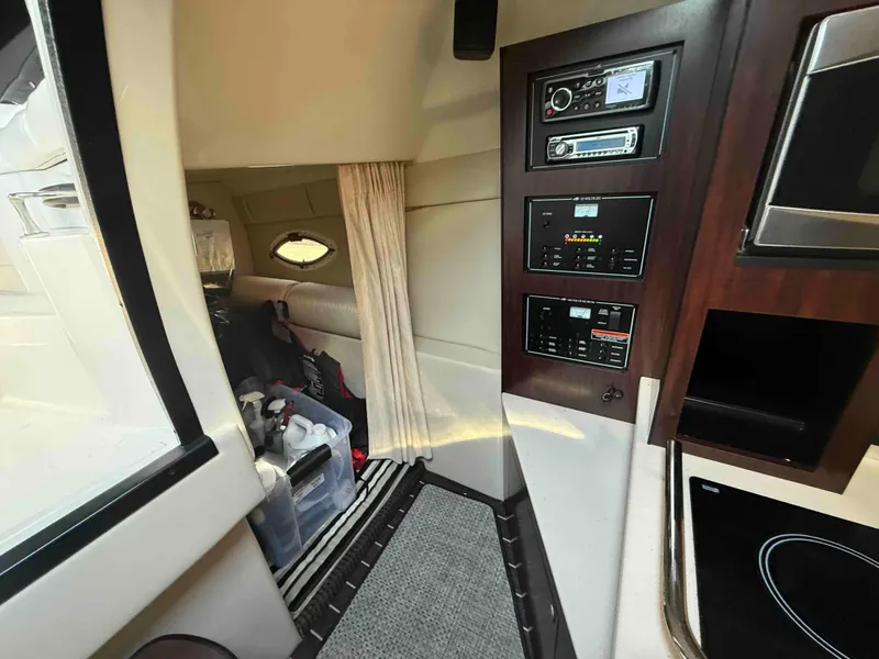 Slide: The Image of Interior of 2013 Monterey 280 SCR boat with control panel and storage area. - 11