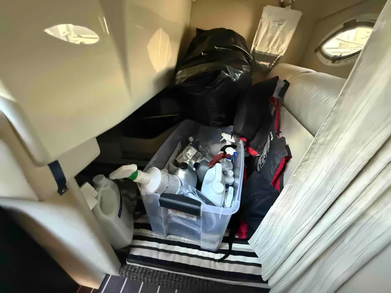 Slide: The Image of Interior storage of 2013 Monterey 280 SCR boat with cleaning supplies and equipment. - 12