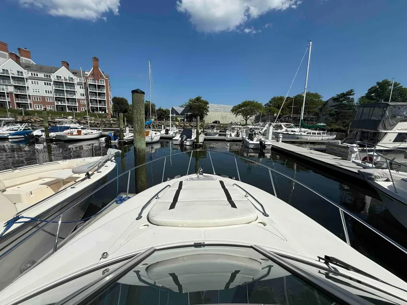 Slide: The Image of 2013 Monterey 280 SCR docked in a marina with surrounding boats and buildings. - 6
