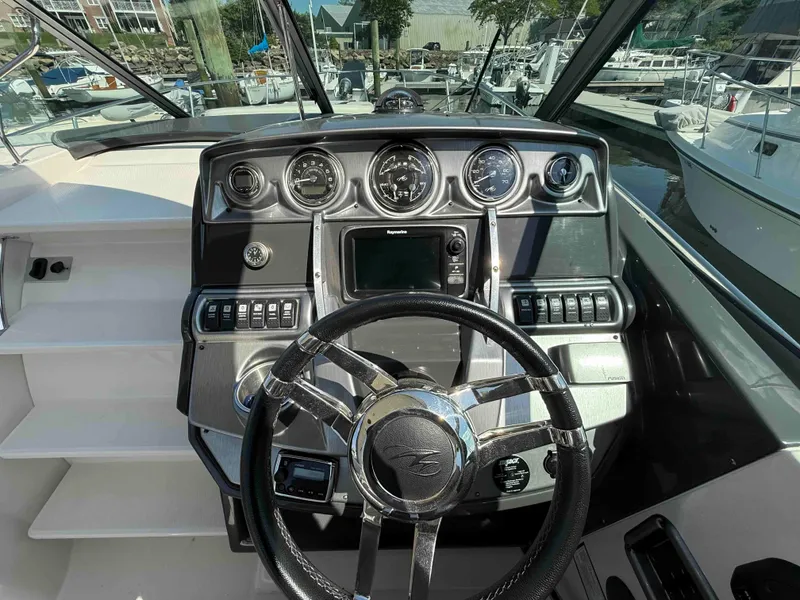 Slide: The Image of Dashboard of a 2013 Monterey 280 SCR boat with steering wheel and gauges. - 7