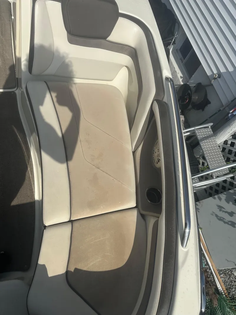 Slide: The Image of 2015 Yamaha Boats 242 Limited interior seating with cup holder and speaker. - 11