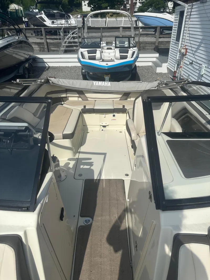 Slide: The Image of 2015 Yamaha Boats 242 Limited interior with seating and dashboard view. - 13