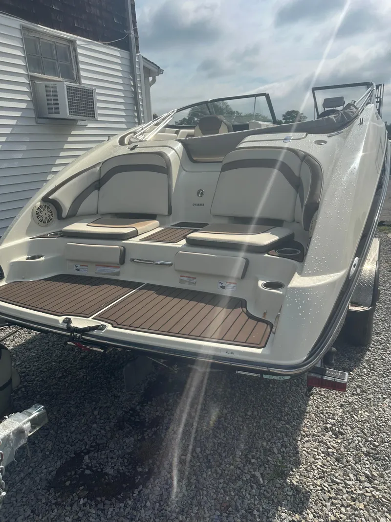 Slide: The Image of 2015 Yamaha Boats 242 Limited, rear view on trailer, showcasing seating and deck. - 4