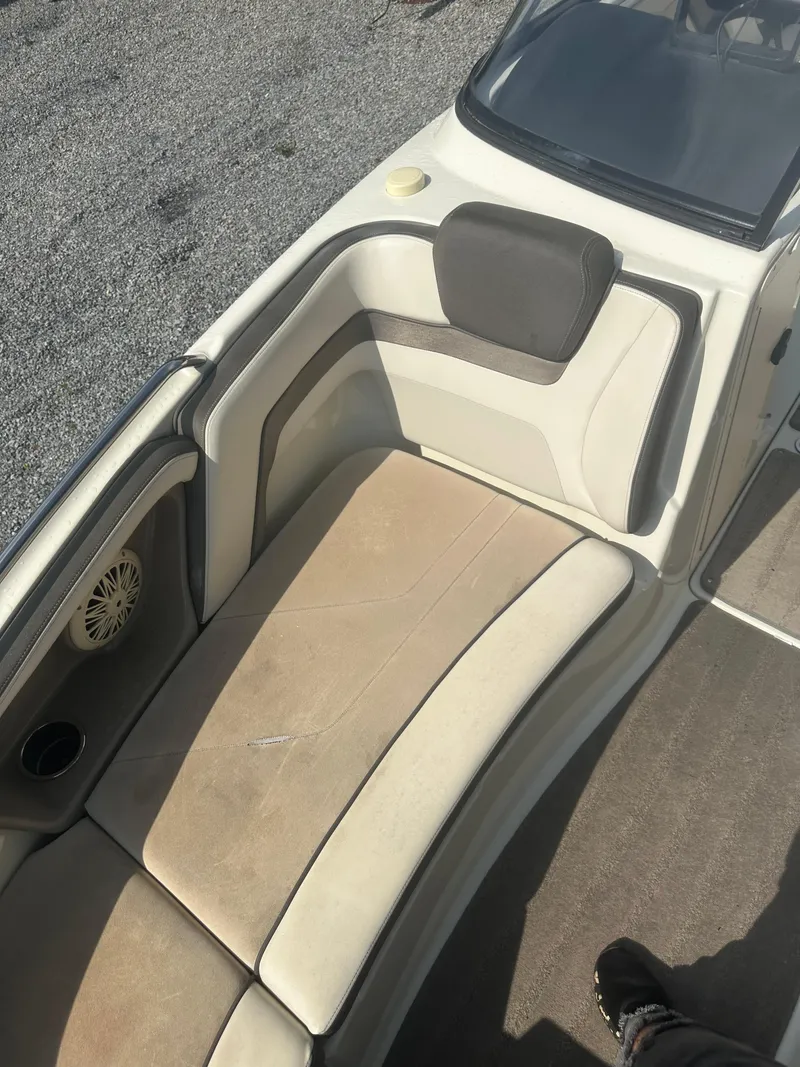 Slide: The Image of 2015 Yamaha Boats 242 Limited interior seating with beige upholstery and speaker. - 9